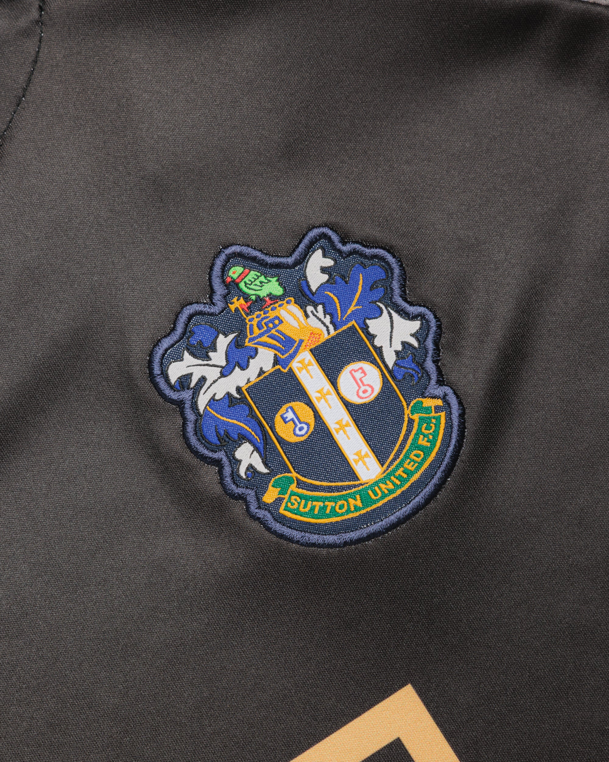 Sutton United 26/27 Vertex Training Tee Black/Dark Grey/Gold