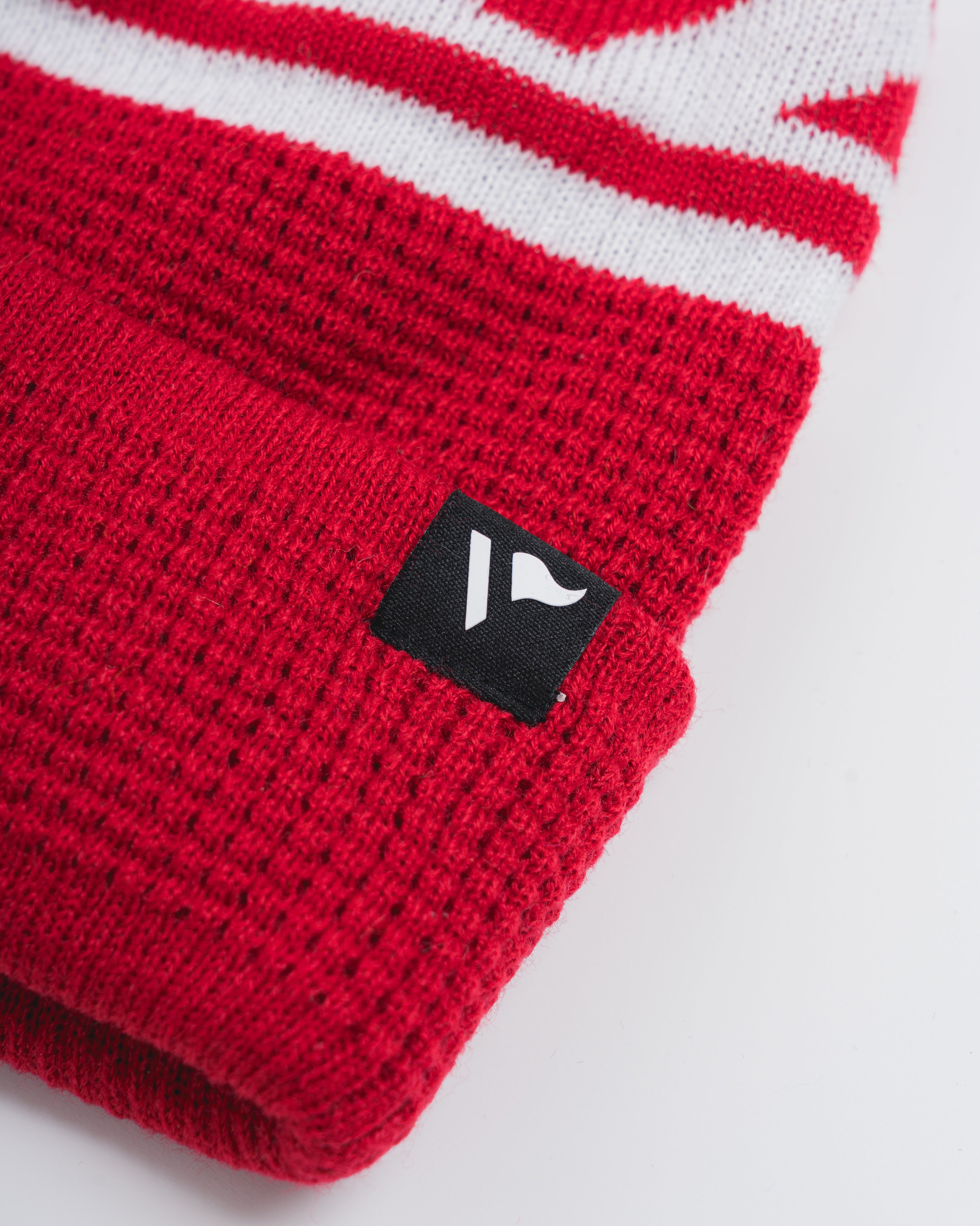 P83976WaffleKnitBobbleHat-Red-White-2_594b4f46-8a7d-47da-ae97-b8fd42a79ac7.jpg